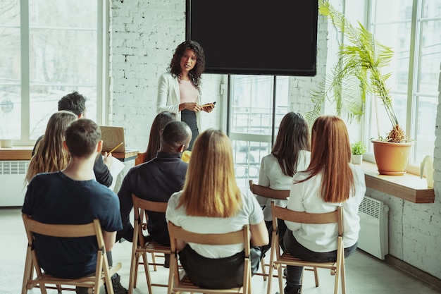 female african american speaker giving presentation hall university workshop_155003 3579